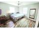 Cozy bedroom with wood flooring, ample natural light, and a bed with built-in storage at 2433 Adams Ave, Deltona, FL 32738