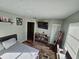 Comfortable bedroom featuring wood floors, a full sized bed and a closet with ample storage at 2433 Adams Ave, Deltona, FL 32738