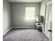 Clean, basic bedroom includes gray carpet, one window with blinds, and a closet with louvered doors at 2433 Adams Ave, Deltona, FL 32738