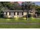 Charming single-story home with a well-maintained lawn, mature trees, and a palm tree in the front yard at 2433 Adams Ave, Deltona, FL 32738