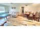 Open-concept living room showcasing a cozy sofa, decorative chairs, and stylish wood-look flooring at 2433 Adams Ave, Deltona, FL 32738