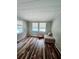 Bright sun room with wood paneling, tiled ceilings, unique floors and ample natural light from the windows at 2433 Adams Ave, Deltona, FL 32738