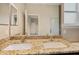 Bathroom with double sinks, granite countertops, large mirrors, shower and ceramic tile flooring at 2495 Se 75Th Blvd, Bushnell, FL 33513