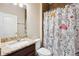 Bright bathroom with granite countertops, ceramic tile flooring, and a shower featuring mushroom-themed curtains at 2495 Se 75Th Blvd, Bushnell, FL 33513