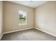 Cozy bedroom features neutral tones, plush carpeting, and a large window for natural light at 2495 Se 75Th Blvd, Bushnell, FL 33513