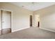 Bedroom featuring neutral carpeting, fresh paint, walk-in closet, and an en-suite bathroom at 2495 Se 75Th Blvd, Bushnell, FL 33513