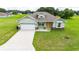 Beautiful single story home with a yellow door, lush lawn, and a two car garage at 2495 Se 75Th Blvd, Bushnell, FL 33513