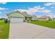 Charming home with well-manicured lawn and a large concrete driveway with a two car garage at 2495 Se 75Th Blvd, Bushnell, FL 33513