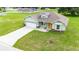 An elevated view of a charming single story home, featuring a lush lawn and driveway at 2495 Se 75Th Blvd, Bushnell, FL 33513
