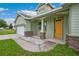 Inviting front porch entrance featuring stylish stone accents and a bright yellow door at 2495 Se 75Th Blvd, Bushnell, FL 33513