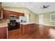 Open kitchen layout with stainless steel appliances, granite countertops, and a large central island at 2495 Se 75Th Blvd, Bushnell, FL 33513