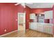 Red bedroom featuring a sink with cabinets and a large doorway to another room at 25025 Cranes Roost Cir, Leesburg, FL 34748