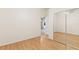 Bedroom with wood floors and a mirrored closet, offering ample storage at 25025 Cranes Roost Cir, Leesburg, FL 34748