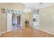 A dining room features wood floors, chandelier, and a view into another room at 25025 Cranes Roost Cir, Leesburg, FL 34748