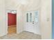 Bright entryway with ceramic tile and large white front door with glass accents at 25025 Cranes Roost Cir, Leesburg, FL 34748
