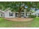Charming single-story home beautifully shaded by a mature tree and featuring neutral toned gravel landscaping at 25025 Cranes Roost Cir, Leesburg, FL 34748