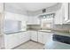 Traditional kitchen with white cabinets and tile floor, offering a bright and clean cooking space at 25025 Cranes Roost Cir, Leesburg, FL 34748