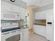 A well-maintained kitchen with white appliances and cabinetry, offering a clean and functional cooking area at 25025 Cranes Roost Cir, Leesburg, FL 34748