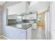 Bright kitchen with white cabinets, modern appliances, breakfast bar and tile flooring at 25025 Cranes Roost Cir, Leesburg, FL 34748