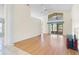 Spacious living room featuring wood floors, large windows and high ceilings with ceiling fan at 25025 Cranes Roost Cir, Leesburg, FL 34748