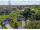 Aerial view of a home with patterned driveway, surrounded by lush landscaping and near a golf course at 2557 Privada Dr, The Villages, FL 32162