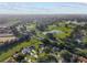 Overhead view featuring a landscaped property near a golf course and water feature in a vibrant community at 2557 Privada Dr, The Villages, FL 32162