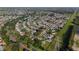 Aerial view of a residential community with tree-lined streets and well-maintained homes at 2557 Privada Dr, The Villages, FL 32162