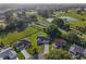 Panoramic aerial view showcases a home near a golf course and water feature in a vibrant community at 2557 Privada Dr, The Villages, FL 32162