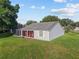 Aerial view of the home showing the rear exterior, backyard, and screened-in back porch at 2557 Privada Dr, The Villages, FL 32162