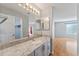 Bathroom features a granite countertop vanity and a view into the bedroom at 2557 Privada Dr, The Villages, FL 32162