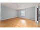 Bright bedroom with laminate floors and sliding glass door to patio at 2557 Privada Dr, The Villages, FL 32162
