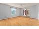 Bedroom with wood floors, large window, and sliding door leading to sunroom at 2557 Privada Dr, The Villages, FL 32162