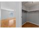 Bedroom with view into closet featuring wood floors and a ceiling fan at 2557 Privada Dr, The Villages, FL 32162