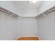 Walk-in closet featuring wood floors, wire shelving and plenty of storage space at 2557 Privada Dr, The Villages, FL 32162