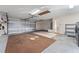 Spacious garage with storage shelves, utility sink, and an automatic door, ready for your vehicles and projects at 2557 Privada Dr, The Villages, FL 32162