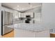 Modern kitchen features stainless steel appliances, gray cabinets, and granite countertops at 2557 Privada Dr, The Villages, FL 32162