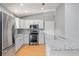 Bright kitchen with gray cabinets, stainless steel appliances, and granite countertops at 2557 Privada Dr, The Villages, FL 32162