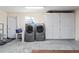 Laundry room with washer, dryer, and storage at 2557 Privada Dr, The Villages, FL 32162