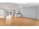 Bright living room with light wood floors, open to a modern kitchen and sliding glass doors at 2557 Privada Dr, The Villages, FL 32162