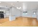 Open-concept living and kitchen area with light-colored walls and laminate floors at 2557 Privada Dr, The Villages, FL 32162