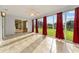 Inviting sunroom featuring tiled flooring, a ceiling fan, and large windows with views of the fenced-in yard at 2557 Privada Dr, The Villages, FL 32162