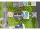 Aerial view of home with solar panels, lush landscaping, pool, dock and boat lift at 2610 Florence Dr, Kissimmee, FL 34744