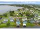 Wide angle aerial of home with community lake, solar panels and mature landscaping in a outlined red box at 2610 Florence Dr, Kissimmee, FL 34744