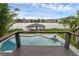 Backyard featuring pool, access to the lake, boat dock, and serene surroundings at 2610 Florence Dr, Kissimmee, FL 34744