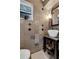 Charming bathroom with distinctive tiling, a modern vessel sink, and natural light from the window at 2610 Florence Dr, Kissimmee, FL 34744