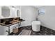 Bathroom featuring dual sinks, modern standalone tub, geometric tile floors, and modern finishes at 2610 Florence Dr, Kissimmee, FL 34744