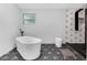Bathroom featuring modern standalone tub, geometric tile floors, and modern finishes at 2610 Florence Dr, Kissimmee, FL 34744