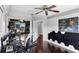 Stylish bedroom featuring dark hardwood floors, a ceiling fan, and unique wall decor and workspace at 2610 Florence Dr, Kissimmee, FL 34744