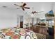 Spacious bedroom with a ceiling fan, wood floors, and a mirrored closet at 2610 Florence Dr, Kissimmee, FL 34744