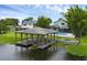 Waterfront home featuring a covered dock with boat lift and direct access to the lake, creating an ideal boater's paradise at 2610 Florence Dr, Kissimmee, FL 34744